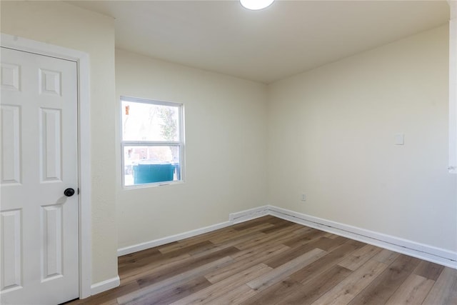 empty room with light hardwood / wood-style flooring