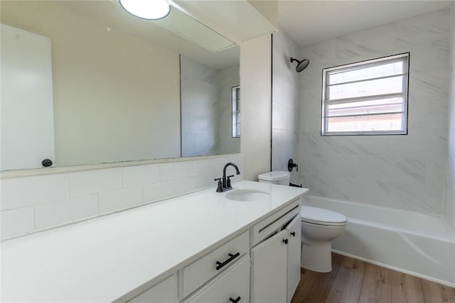 2916 SW 61st St, Oklahoma City, OK 73159 - bathroom with vanity, washtub / shower combination, wood finished floors, and toilet