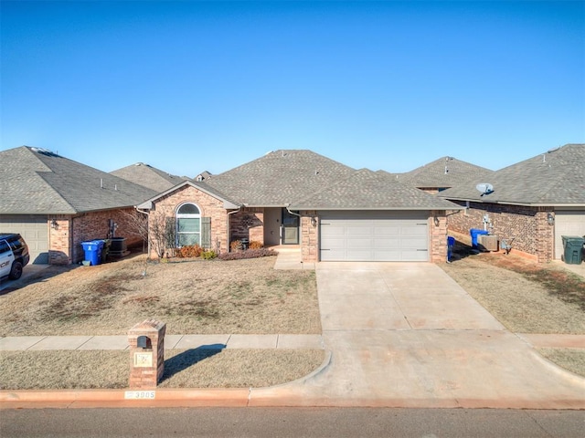 ranch-style house featuring central AC and a garage