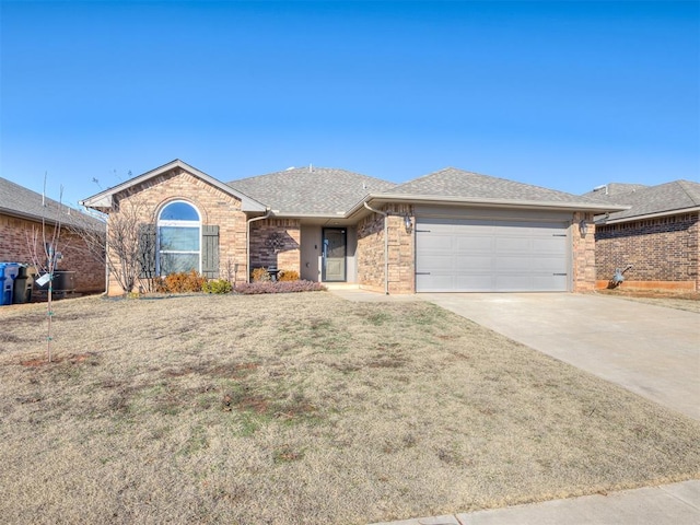 ranch-style home featuring a garage, a shingled roof, brick siding, driveway, and a front yard