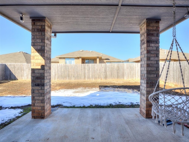 snow covered patio with fence private yard