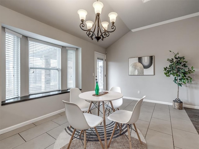 dining space with lofted ceiling, tile patterned flooring, and baseboards