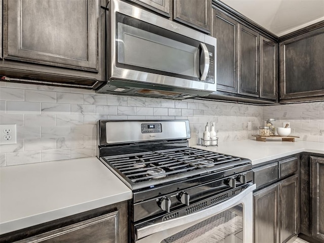 kitchen featuring appliances with stainless steel finishes, light countertops, dark brown cabinetry, and backsplash