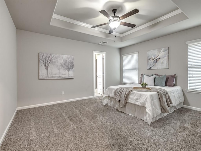 bedroom with visible vents, baseboards, ornamental molding, carpet, and a tray ceiling