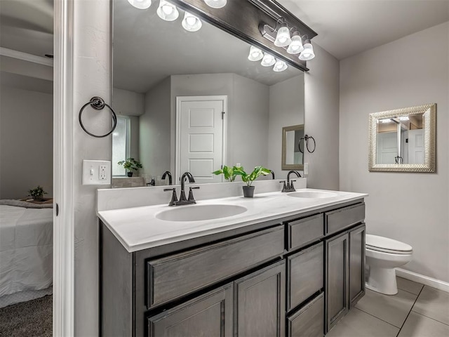 full bathroom featuring toilet, tile patterned flooring, double vanity, and a sink