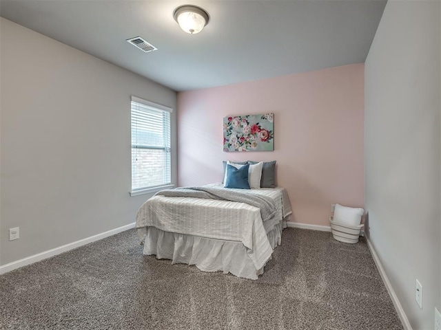 carpeted bedroom featuring visible vents and baseboards