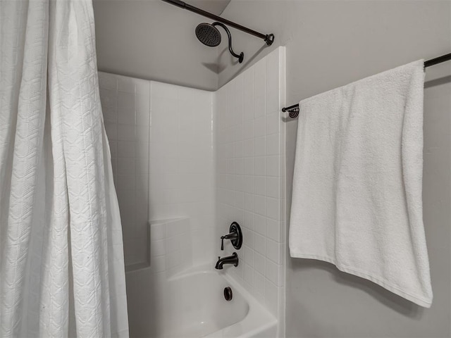 bathroom with shower / bath combo with shower curtain