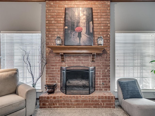 carpeted living room featuring a healthy amount of sunlight and a fireplace