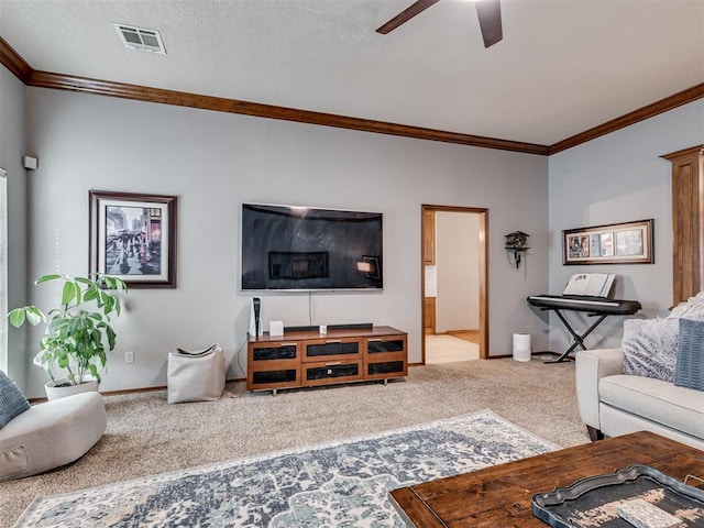 living room with crown molding, light colored carpet, and ceiling fan