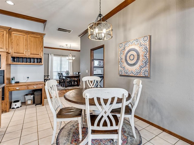 tiled dining area with an inviting chandelier and ornamental molding