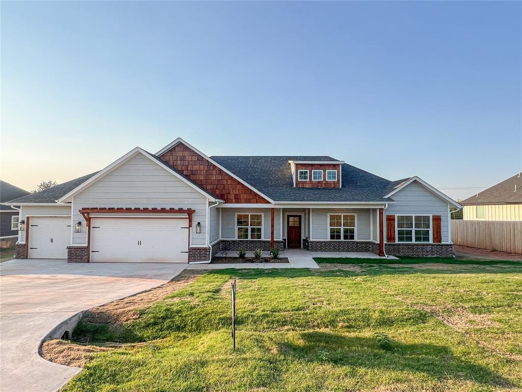 craftsman-style home featuring a yard and a garage