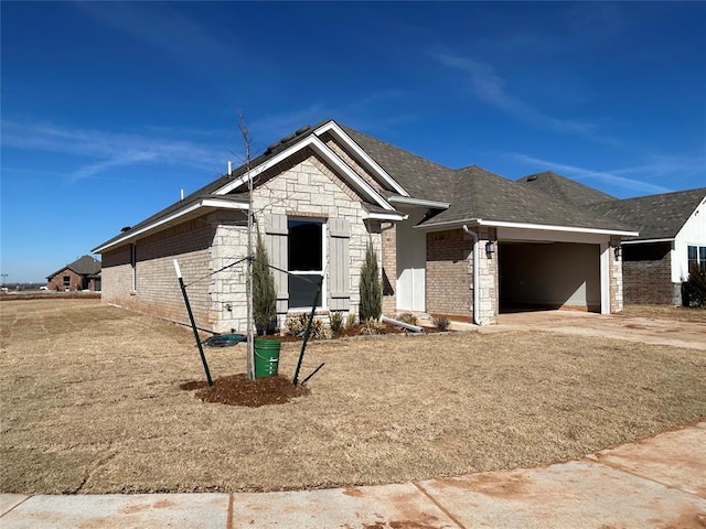 view of front of home featuring stone siding, concrete driveway, brick siding, and an attached garage