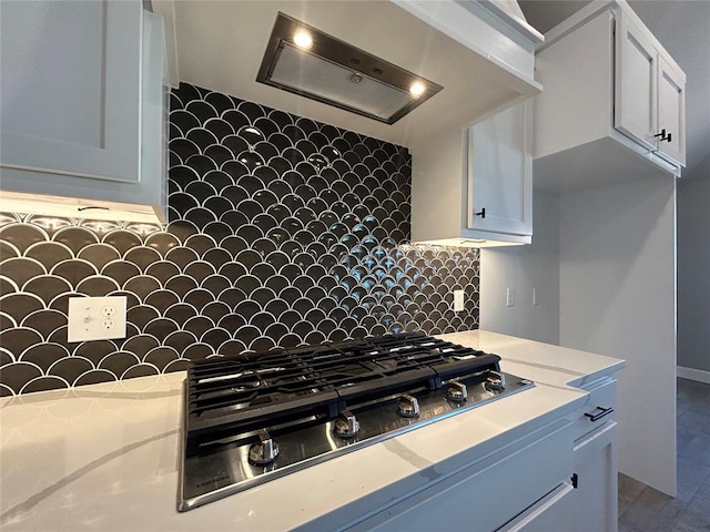 kitchen with white cabinets, stainless steel gas cooktop, and light countertops