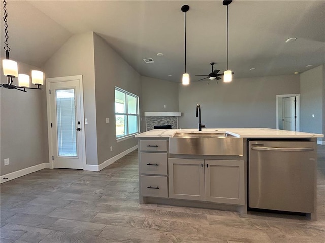 kitchen with visible vents, dishwasher, an island with sink, decorative light fixtures, and light countertops