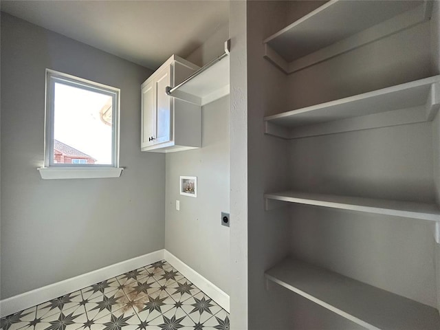 laundry area with hookup for an electric dryer, washer hookup, baseboards, cabinet space, and light floors