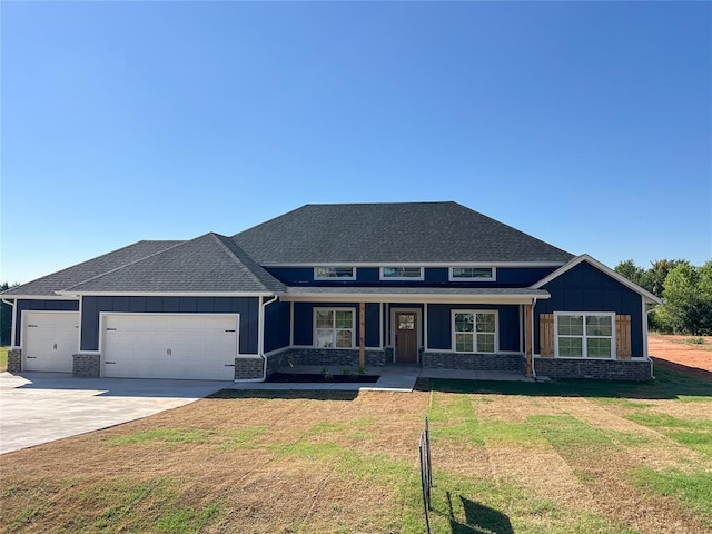 view of front of property featuring a garage and a front lawn