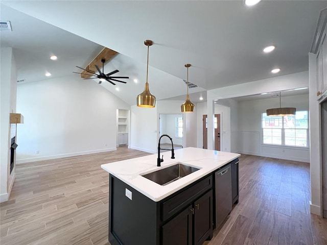 kitchen with dishwasher, sink, lofted ceiling with beams, light hardwood / wood-style floors, and a center island with sink