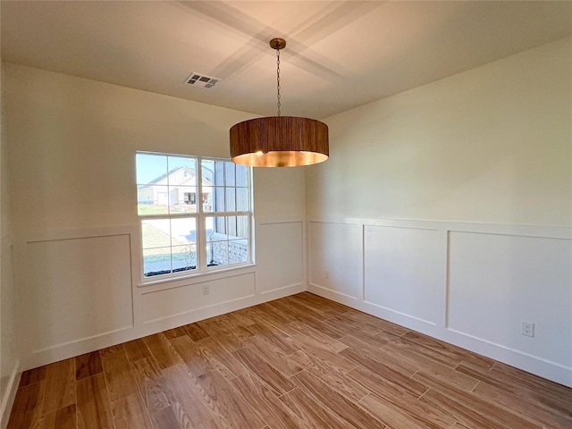 unfurnished dining area featuring hardwood / wood-style flooring