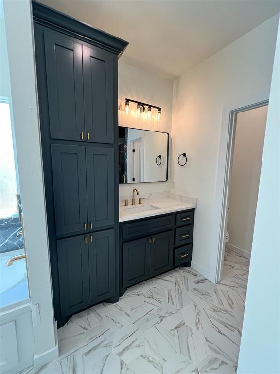 bathroom with vanity and toilet