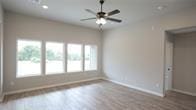 unfurnished room featuring ceiling fan and wood-type flooring