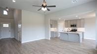 kitchen with kitchen peninsula, light hardwood / wood-style floors, and ceiling fan