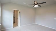 carpeted empty room with ceiling fan and vaulted ceiling