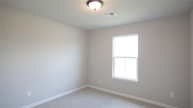 empty room featuring carpet floors and a healthy amount of sunlight