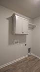 laundry area featuring cabinets, hookup for a washing machine, hookup for an electric dryer, and wood-type flooring