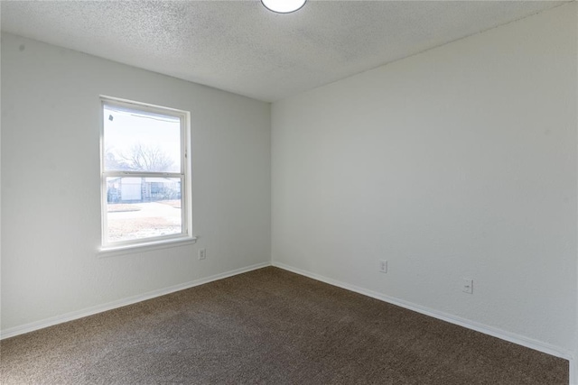 spare room featuring a textured ceiling and carpet floors