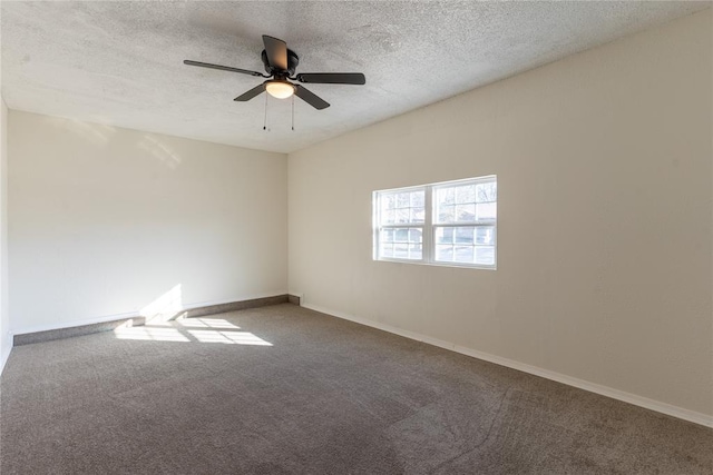 spare room featuring ceiling fan, carpet, and a textured ceiling