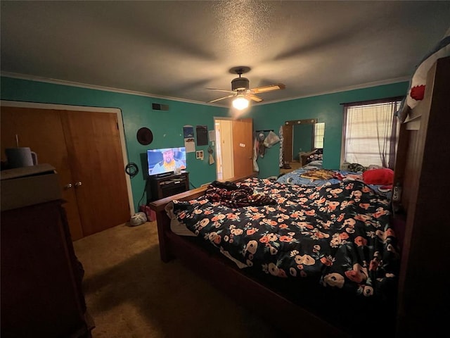 carpeted bedroom featuring ceiling fan, crown molding, and a textured ceiling