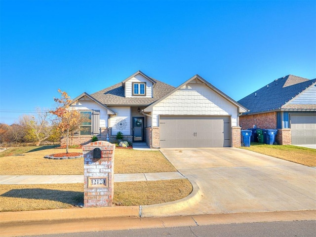 view of front of home featuring a garage and a front lawn