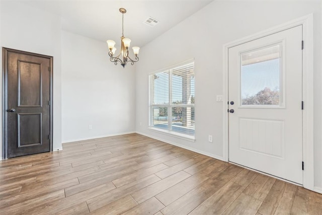 entrance foyer with a chandelier and light wood-type flooring