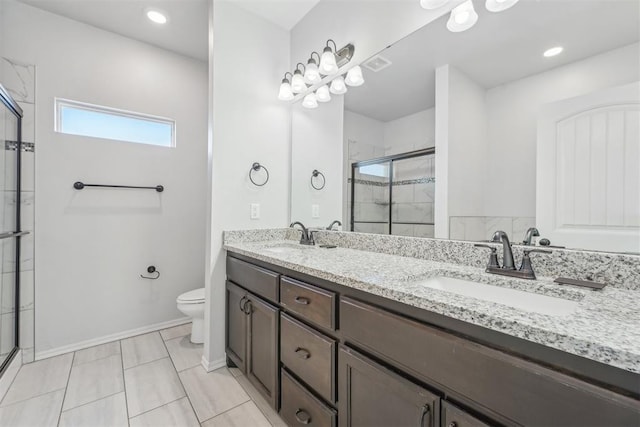 bathroom with tile patterned flooring, vanity, toilet, and walk in shower