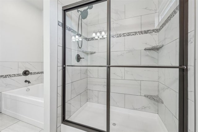 bathroom featuring tile patterned floors and independent shower and bath