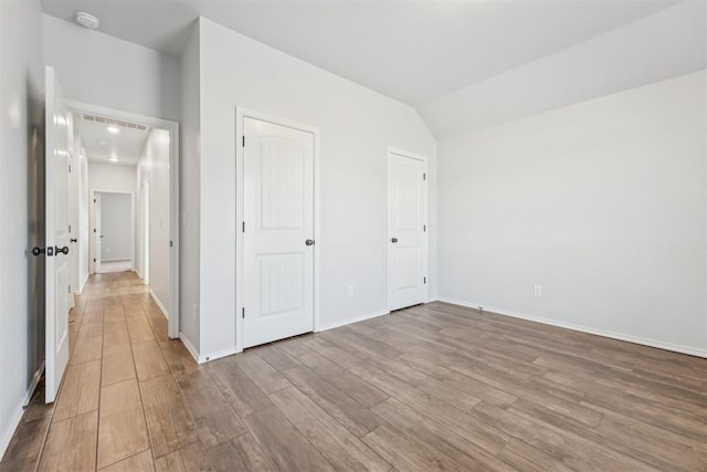 unfurnished bedroom featuring light wood-type flooring and a closet