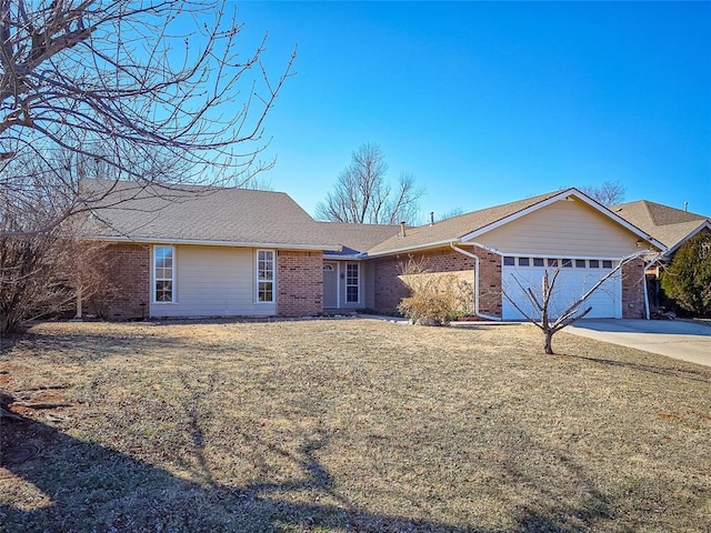 ranch-style house featuring a garage and a front yard