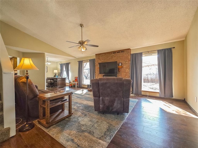 living room with a healthy amount of sunlight, a textured ceiling, and lofted ceiling