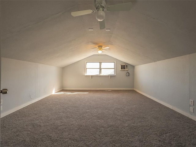 bonus room with carpet floors, an AC wall unit, and lofted ceiling