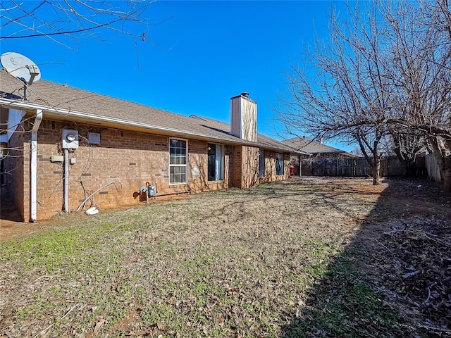 back of property featuring a yard