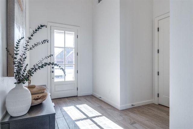 doorway to outside with light wood-type flooring