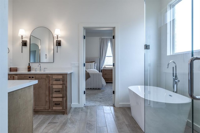 bathroom featuring a tub to relax in and vanity