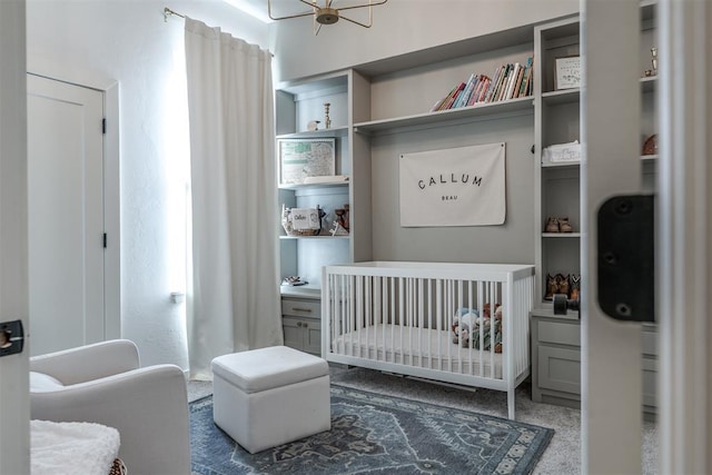 carpeted bedroom featuring a crib