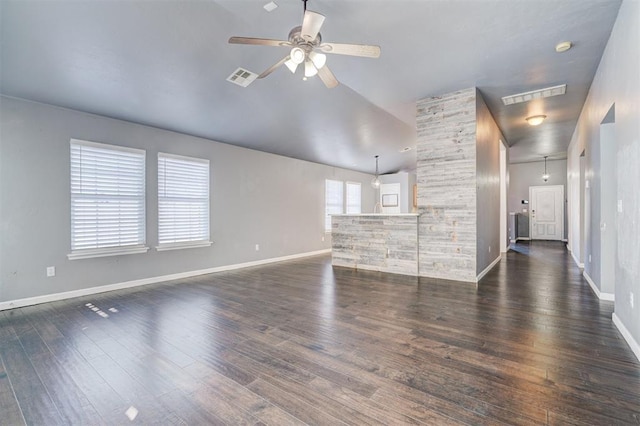 unfurnished living room with ceiling fan, vaulted ceiling, and dark hardwood / wood-style flooring