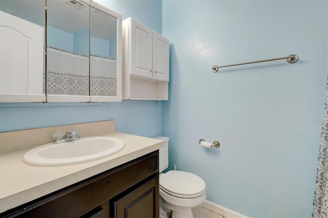 bathroom with toilet and vanity