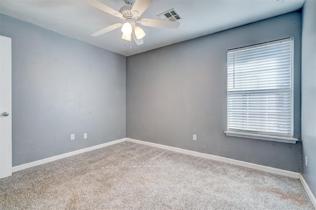 carpeted spare room with ceiling fan