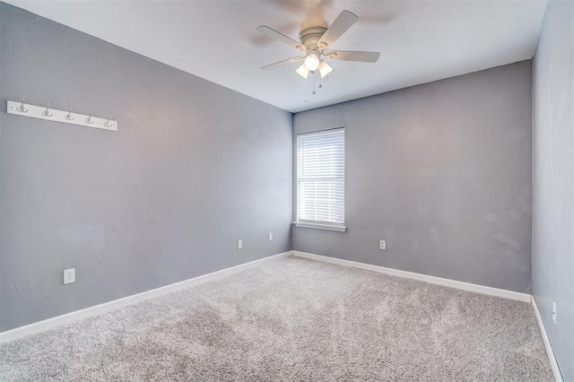 empty room with ceiling fan and carpet