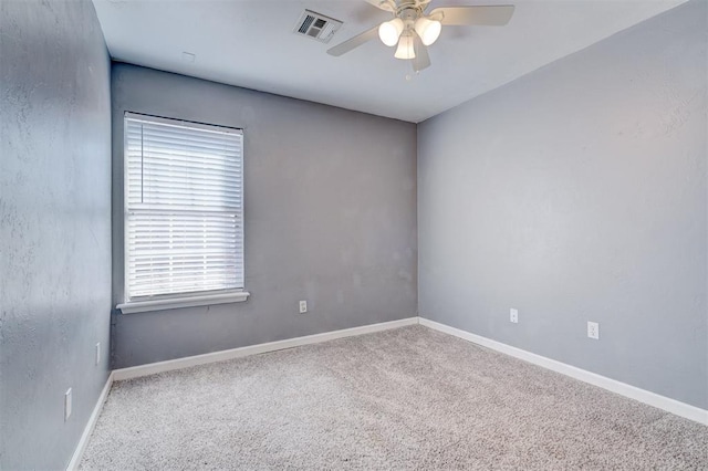 spare room featuring ceiling fan and carpet flooring