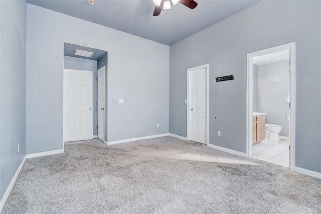 unfurnished bedroom with ceiling fan, connected bathroom, and light carpet