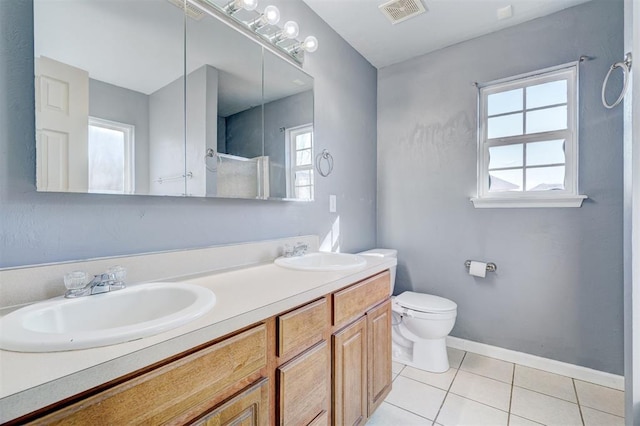 bathroom featuring toilet, vanity, and tile patterned floors